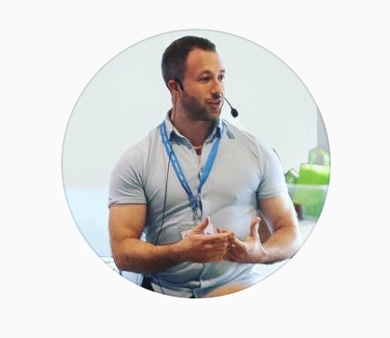 A promotional graphic featuring a circular photo of Dean Attwood speaking with a headset microphone, alongside the logos for Dean Attwood Coaching and Integral Workplace Wellness